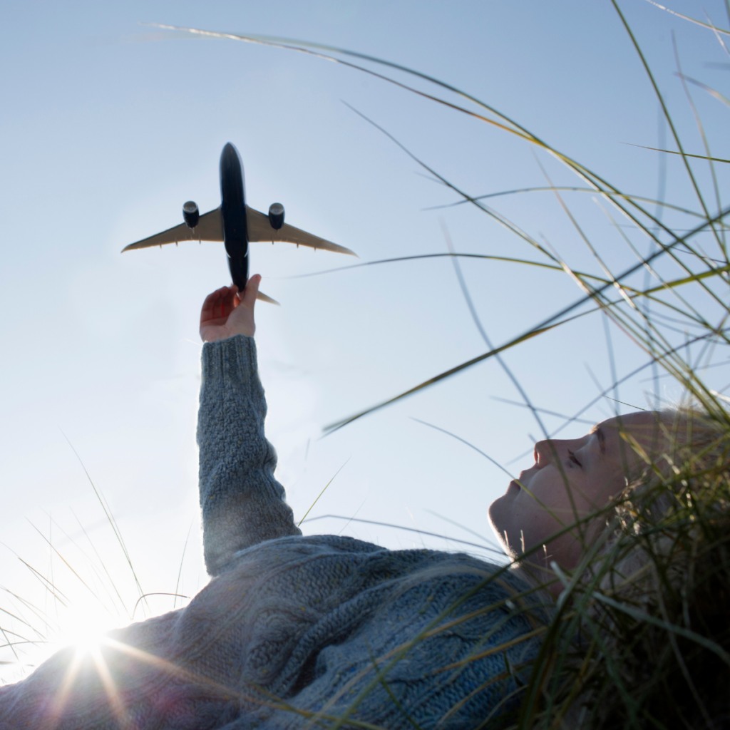 pLANE TOY HELD UP TO THE SKY