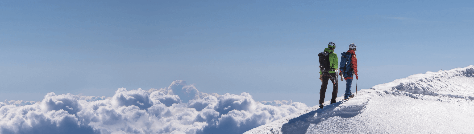 Hikers in a mountain landscape with clear blue sky