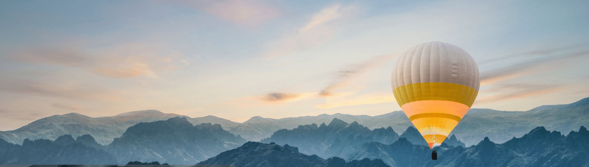 Hot air balloon over mountains