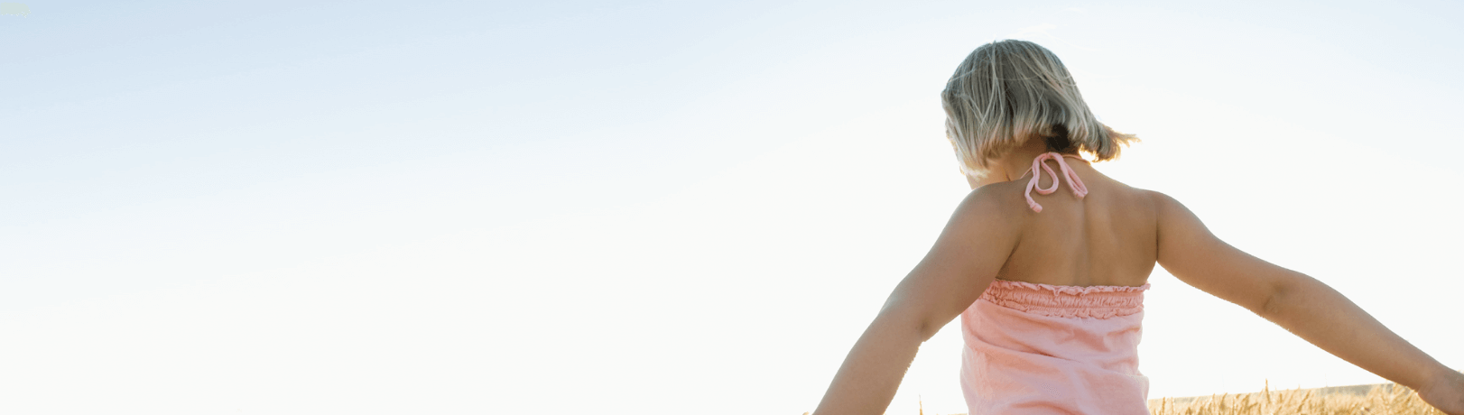 Girl in wheat field on a sunny day