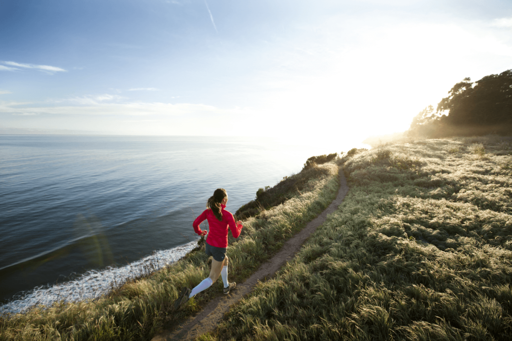 Female runner on track along seaside